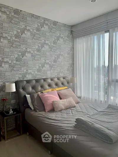 Chic bedroom with cityscape wallpaper and plush bedding in modern apartment