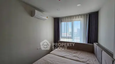 Cozy bedroom with air conditioning and large window view
