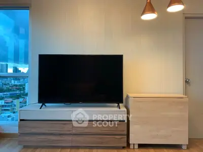 Modern living room with sleek TV stand and city view from window