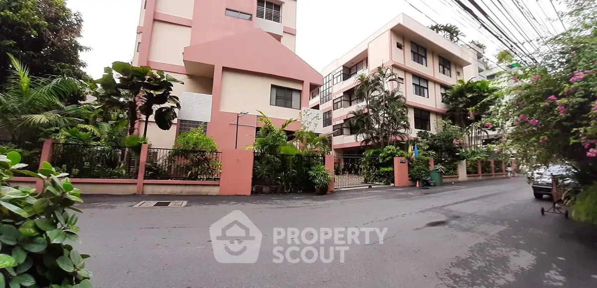 Charming residential building with lush greenery and modern architecture in a serene neighborhood.