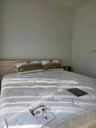 Modern bedroom with stylish bedding and natural light, perfect for relaxation and comfort.
