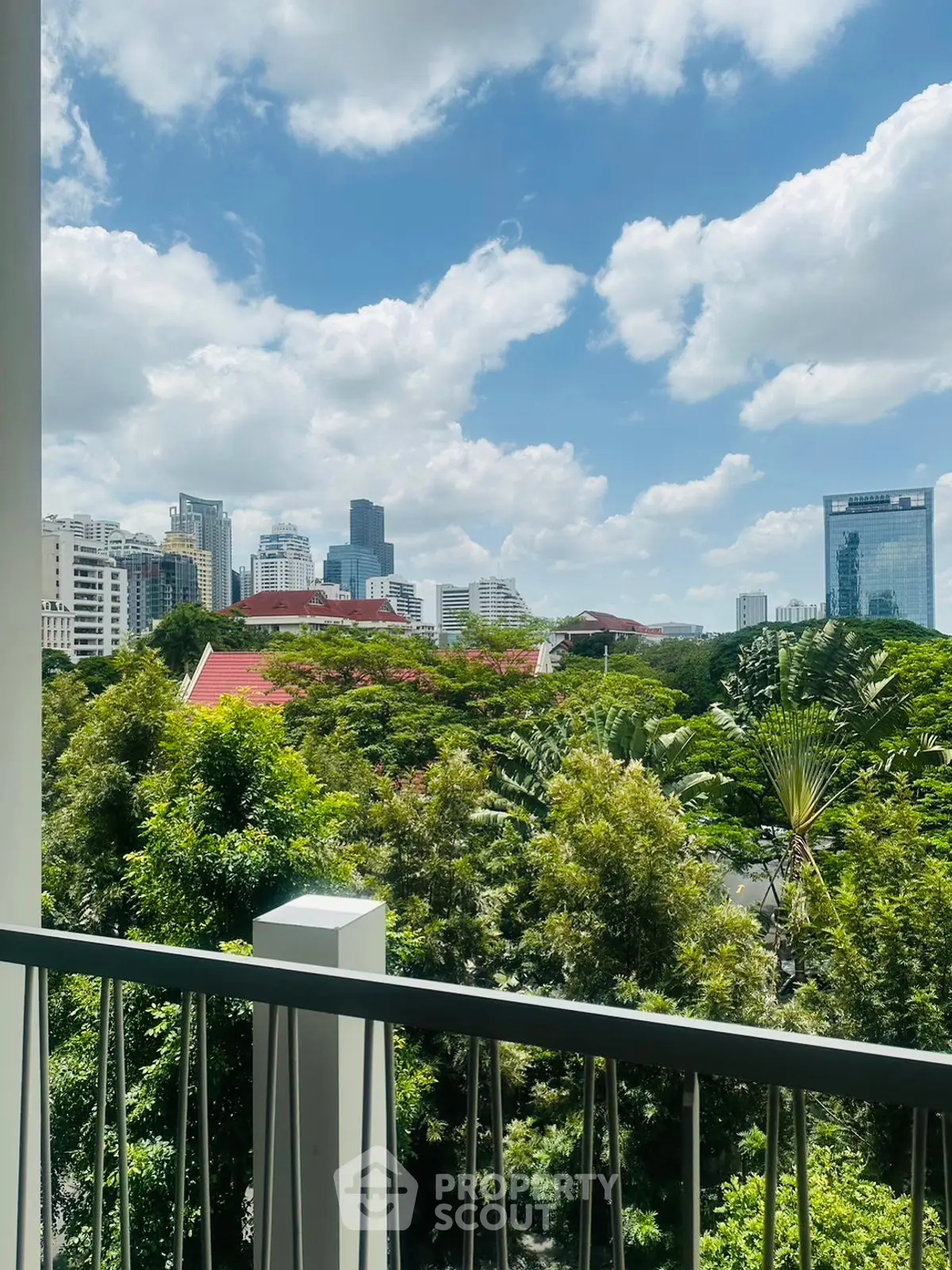 Stunning cityscape view from a lush green balcony, perfect urban living.