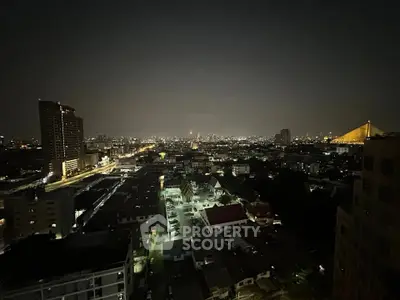 Stunning nighttime cityscape view from high-rise building balcony.