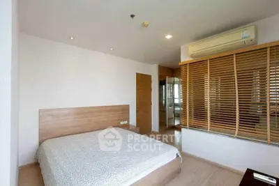Spacious modern bedroom with wooden accents and air conditioning in a stylish apartment.