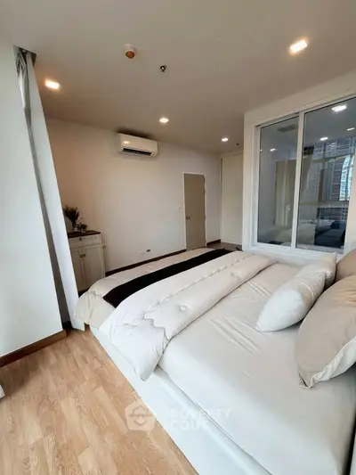 Spacious modern bedroom with large windows and elegant decor