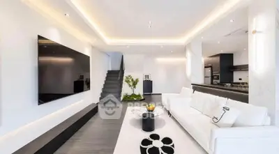 Luxurious modern living room with sleek design and open kitchen layout