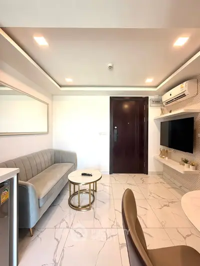 Modern living room with sleek furniture and marble flooring, featuring a wall-mounted TV and stylish lighting.