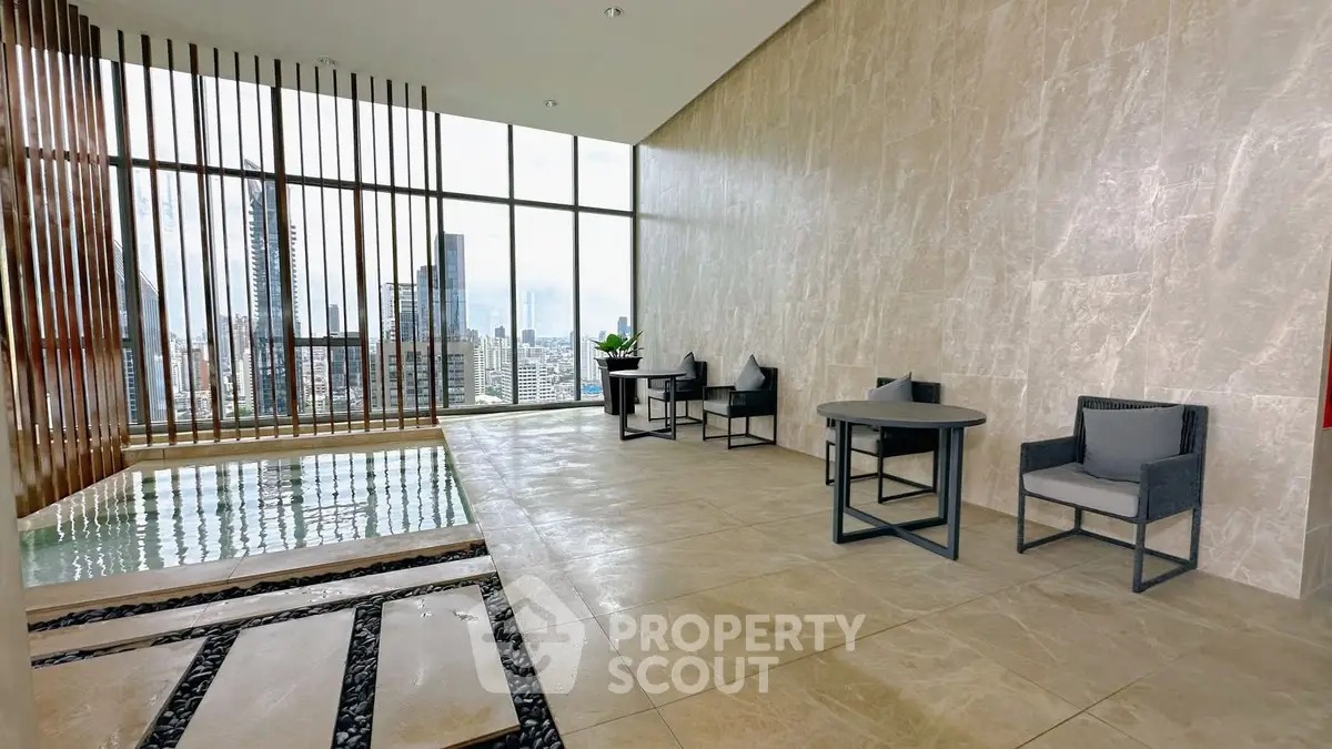 Luxurious rooftop area with stunning city view and modern seating.