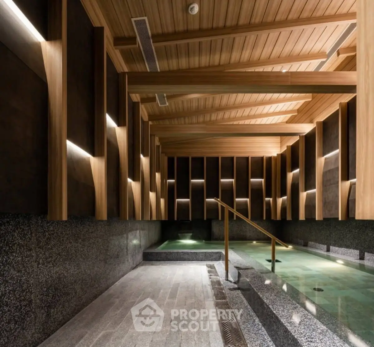 Luxurious indoor pool with modern wooden ceiling and ambient lighting