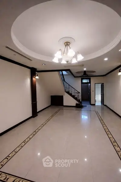 Elegant interior with chandelier and staircase in spacious living area