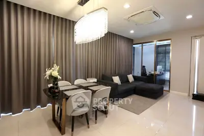 Modern living room with elegant dining area and stylish decor