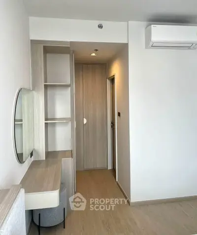 Modern minimalist bedroom with built-in storage and air conditioning