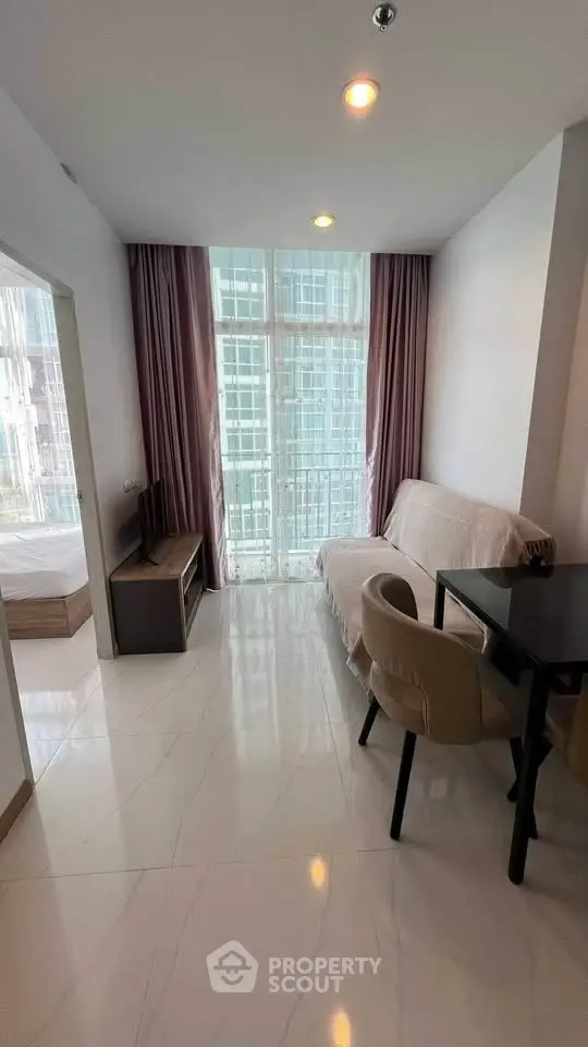 Modern living room with natural light and stylish furniture in a high-rise apartment.