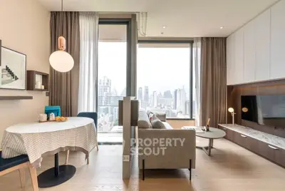 Modern living room with city view, stylish furniture, and elegant decor in a high-rise apartment.