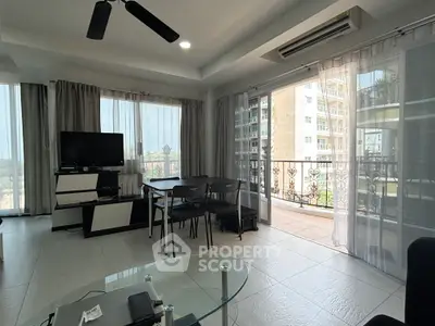 Spacious living room with large windows and balcony access in modern apartment.