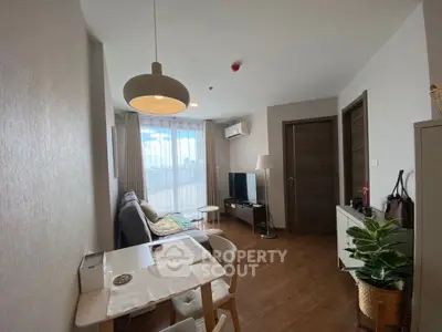 Cozy living room with modern decor and natural light in a stylish apartment.