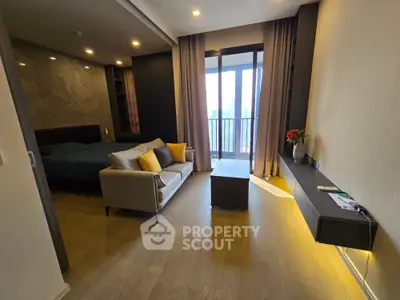 Modern living room with cozy sofa, elegant decor, and balcony view in a stylish apartment.