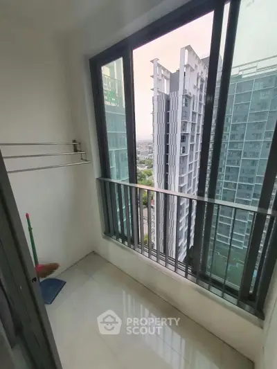 Modern high-rise balcony with city view, perfect for urban living.