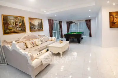 Luxurious living room with elegant sofa and pool table, perfect for entertainment and relaxation.