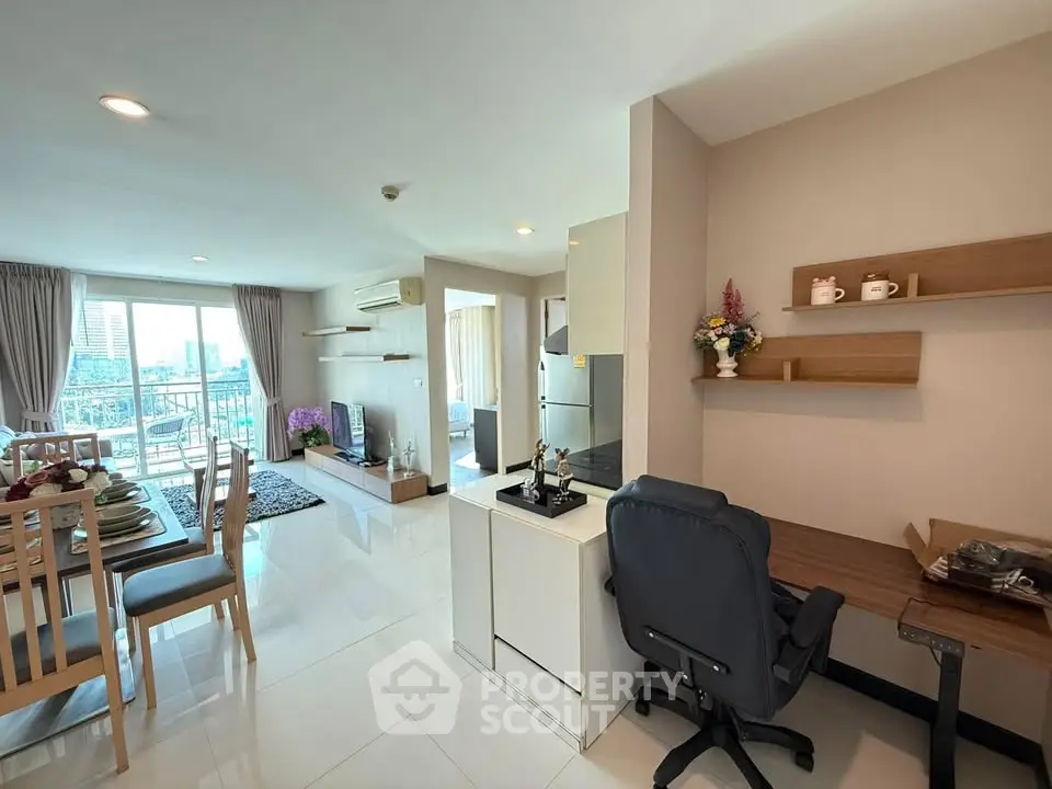 Spacious open-plan living room with dining area and balcony view