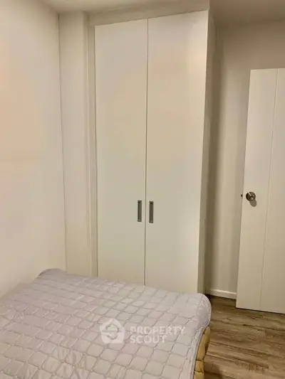 Cozy bedroom with minimalist wardrobe and stylish flooring