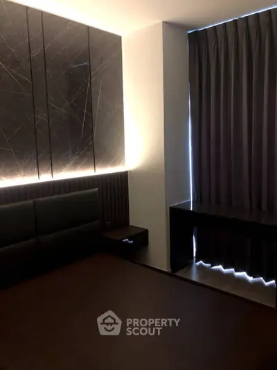 Modern bedroom with elegant dark decor and ambient lighting