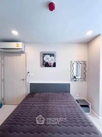 Modern bedroom with stylish decor and air conditioning in a contemporary apartment.