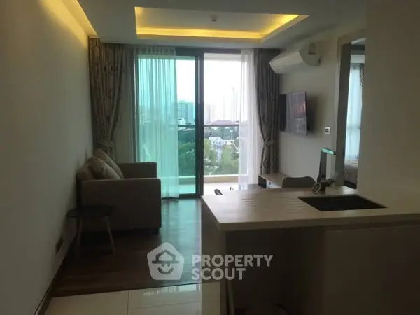 Modern living room with balcony and city view, featuring sleek furniture and ambient lighting.