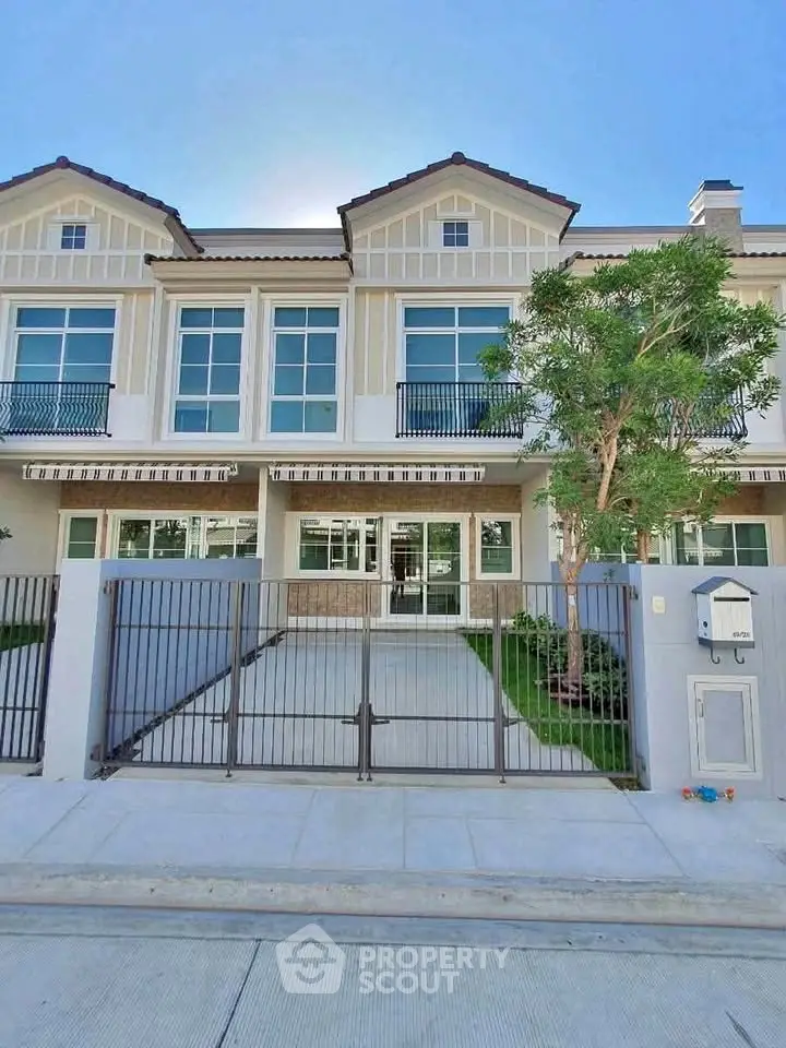 Elegant townhouse exterior with modern design and lush greenery, perfect for family living.