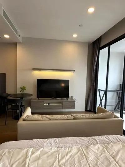 Modern living room with sleek furniture and balcony access