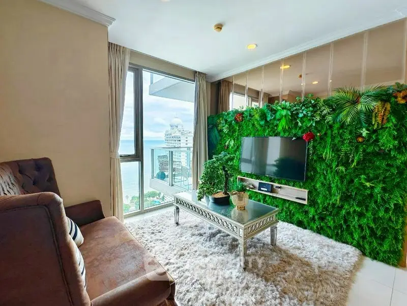 Luxurious living room with ocean view and lush green wall