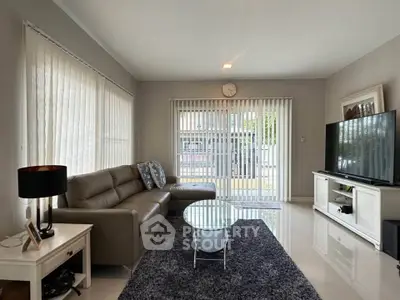 Modern living room with sleek furniture and large windows for natural light.