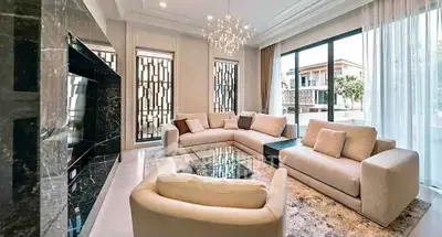 Luxurious modern living room with elegant sofas and large windows offering a stunning view.