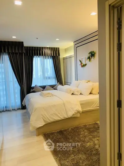 Luxurious bedroom with elegant decor and natural light, perfect for relaxation.