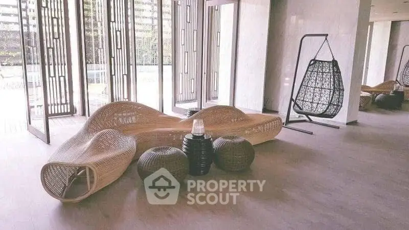 Stylish modern living room with unique wicker furniture and large windows