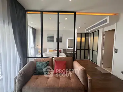 Modern living room with glass partition and cozy sofa in stylish apartment