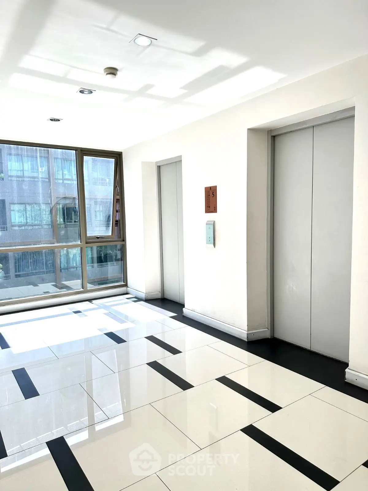 Modern building elevator lobby with sleek design and natural light