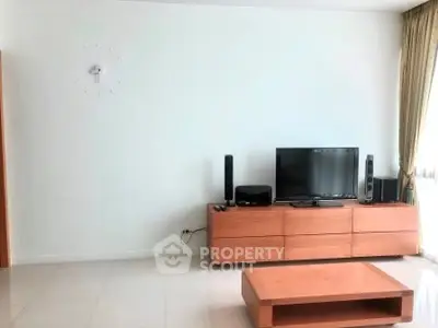 Modern living room with sleek wooden furniture and entertainment setup
