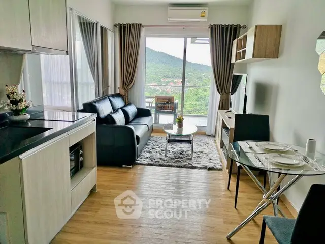 Modern living room with mountain view, sleek furniture, and open layout.