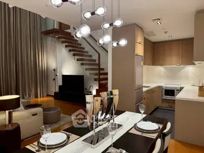 Modern open-plan living room with elegant dining area and stylish kitchen.