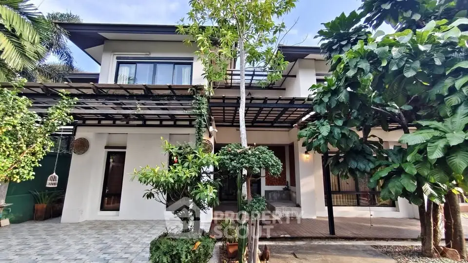 Stunning modern two-story house with lush garden and spacious driveway, perfect for family living.