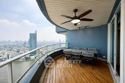 Stunning high-rise balcony with panoramic city view and elegant outdoor seating.