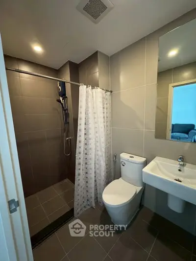 Modern bathroom with sleek shower and contemporary fixtures in stylish apartment.