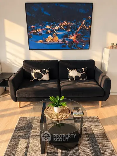 Chic living room with modern black sofa, stylish decor, and vibrant wall art, perfect for urban living.