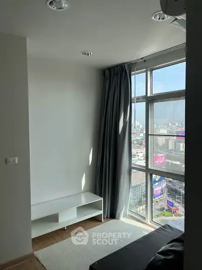 Modern apartment with large windows offering stunning city views and natural light.
