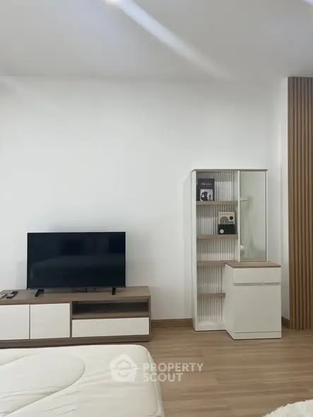 Modern living room with sleek TV unit and stylish storage cabinet.