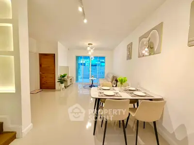 Spacious modern living and dining area with elegant decor and natural light.
