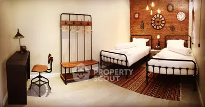 Charming industrial-style bedroom with twin beds and vintage decor accents.