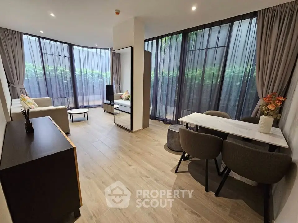 Spacious modern living room with floor-to-ceiling windows and elegant decor