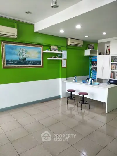 Bright office space with green accent wall and modern furnishings